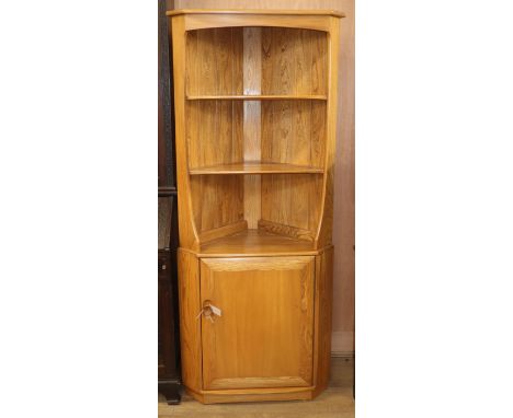 An Ercol Windsor light elm corner cabinet W.76cm