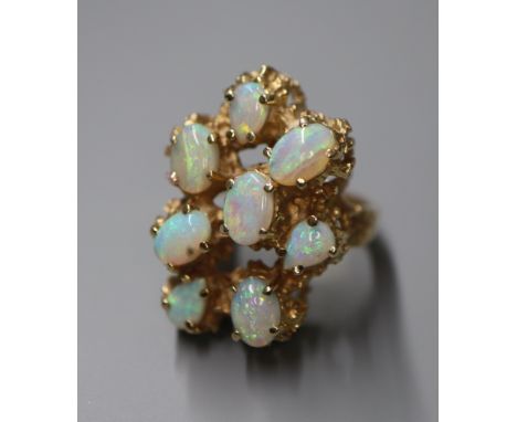 A 14k and eight stone cabochon opal set modernist dress ring, size M/N