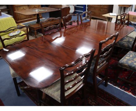 A Regency style mahogany twin pillar dining table Extended 250cm (two spare leaves)