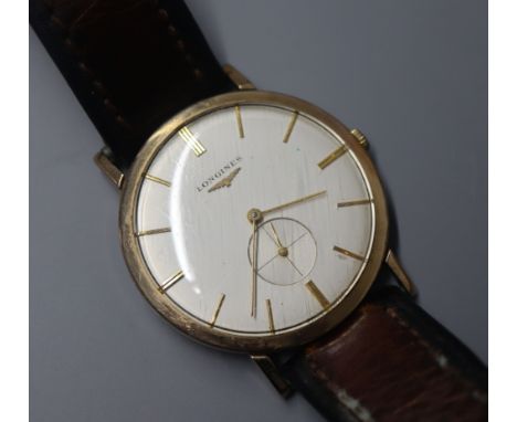 A gentleman's 9ct gold Longines manual wind dress wrist watch, on associated leather strap.