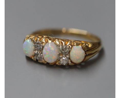 An 18ct and 'plat', white opal and diamond set half hoop ring, size K.