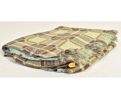 A vintage 20th century hand woollen traditional Welsh blanket. The blanket in hues of cappucino, yellow and sky blue, featuri