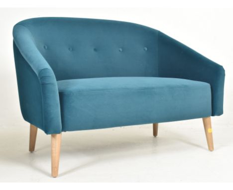 A contemporary designer two seater sofa settee. The sofa having a curved button back backrest terminating to the armrests wit