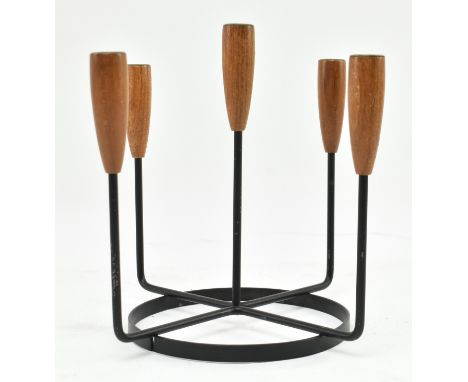 A retro 20th century Danish design candlestick holder. The candlestick having five turned teak holder tops supported by metal