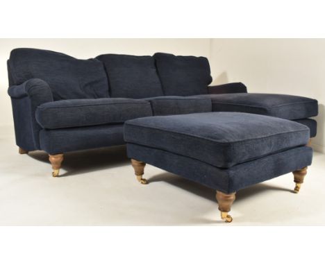 A British Modern Design L-shaped three-seater sofa settee and matching ottoman / footrest. The sofa having a cushioned seat a