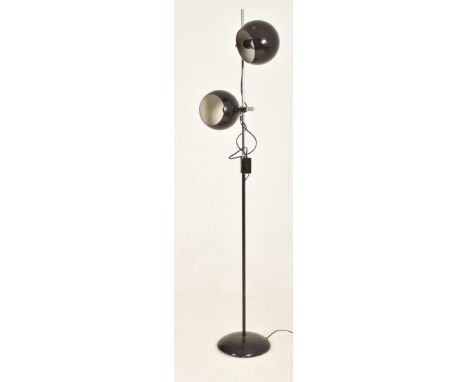 A vintage mid century circa 1960s / 1970s floor standing lamp. The lamp featuring two black enamel adjustable eyeball shades 