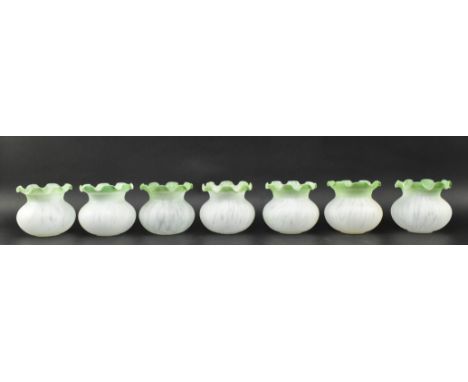 A set of seven vintage 20th century Art Nouveau style frosted glass flower shaped lamp shades. Each having a green coloured r