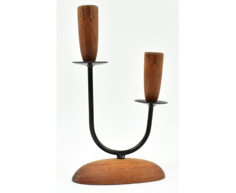 A retro 20th century Danish design candlestick holder. The candlestick having two turned teak holder tops supported by metal 