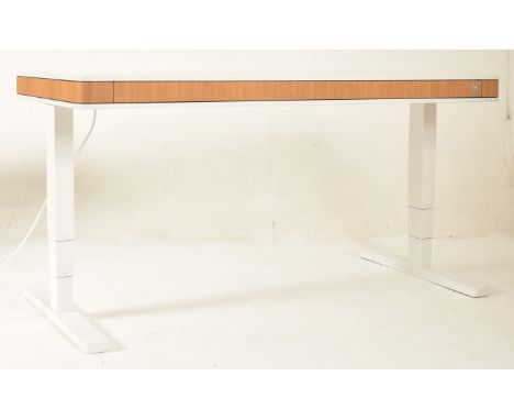 Moll - Model T7 - a large contemporary German high end designer rise and fall desk. The desk is finished in white and oak wit