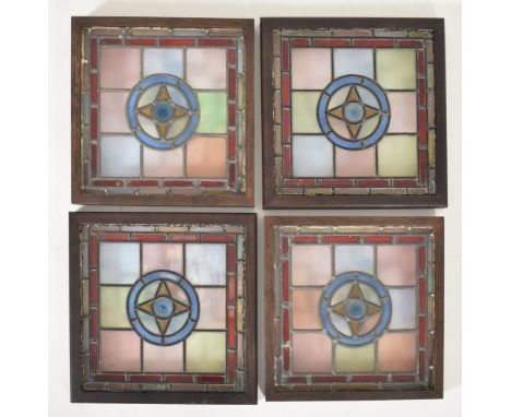 Four vintage mid century decorative stained glass windows. The window panels each featuring geometric shapes &amp; brightly c