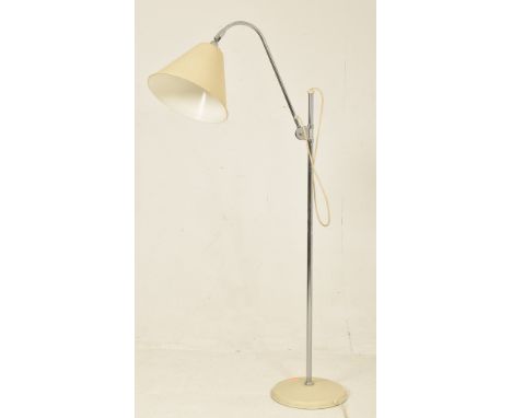 A contemporary Stilnovo manner floor standing lamp light. The lamp having a large cream conical shade supported by an arched 