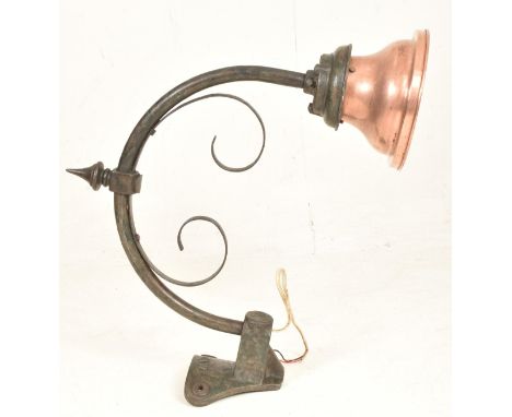 Revo Electric - a 20th century exterior mounted lamp light. The light having an arched sweeping arm supporting a copper shade