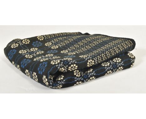 A vintage 20th century hand woollen traditional Welsh blanket. The blanket in wintery tones of blue &amp; white with floral g
