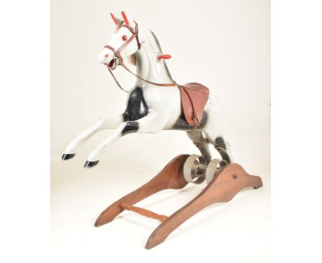 Ragamuffin Toys Ltd. of Guernsey - a vintage 20th century grey painted rocking horse. The horse in a rearing potion raised on