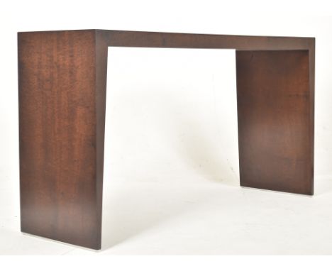 Contemporary high-end designer walnut console table. The table of slender rectangular form having a straight edge top support