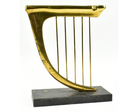 A 20th century brass &amp; slate Hannukah Menorah candle holder in the shape of an harp. The candleholder having nine compart