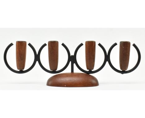 A retro 20th century Danish design candlestick holder. The candlestick having three turned teak holder tops supported by meta