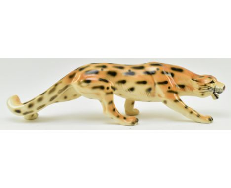 A vintage 20th century hand painted fine bone china figure of leopard. The cat in walking position with mouth open. Unmarked.