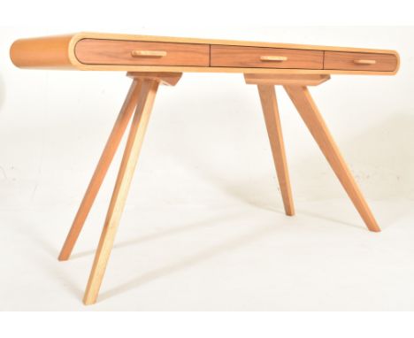 A British Modern Design oak wood console hall table desk. The table having a straight rectangular top with rolled edges. Thre