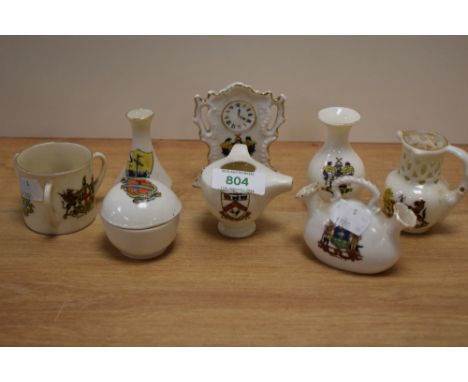 A group of assorted crested ware, to include a Blackpool Progress clock ornament, a Sheffield double vase, and a Chester cres