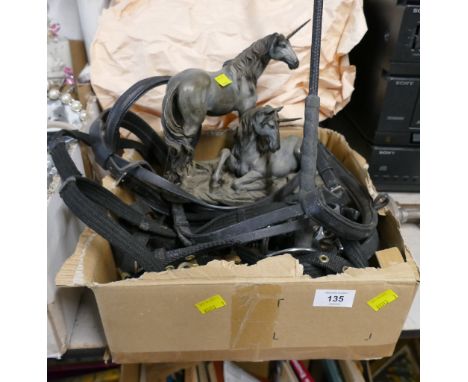 Horse head collars and bridles, unicorn statue and driving whip