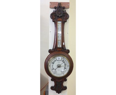 Early 20th Century carved oak wheel aneroid barometer marked: W. Williams, Optician, Swansea.(B.P. 24% incl. VAT)