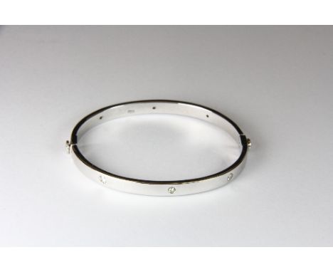 Heavy 9ct white gold bangle set with diamonds.