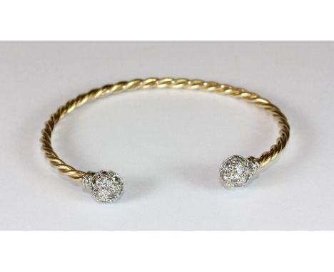 A heavy 9ct gold and diamond set torque bangle