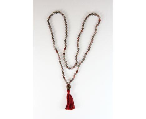 A spinach jade/hardstone string of Tibetan prayer beads with carved skull bead