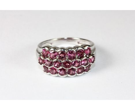 A 9ct white gold and pink sapphire cluster ring (R)