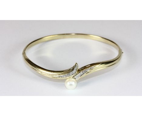A 9ct gold diamond and cultured pearl bangle