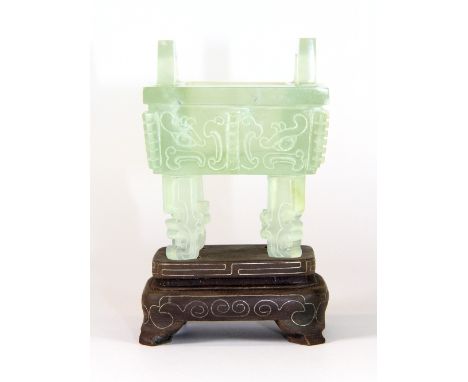 A beautiful carved archaic form jade sensor mounted on a white metal inlaid hardwood stand (H:10cm) Est. £200-300