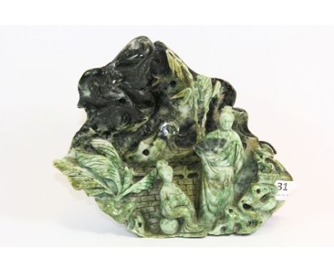 A large Chinese carved jade/hardstone model of two figures in a mountain landscape (H:20.5cm)