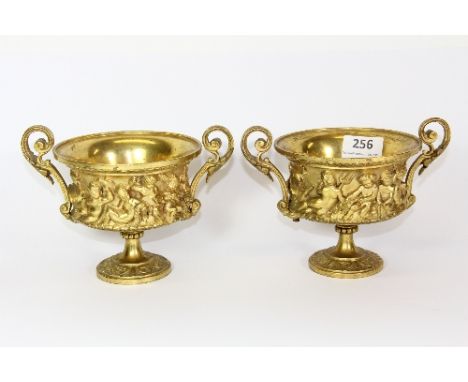 A pair of 19th century gilt bronze urns with cherub decoration, H 13cm