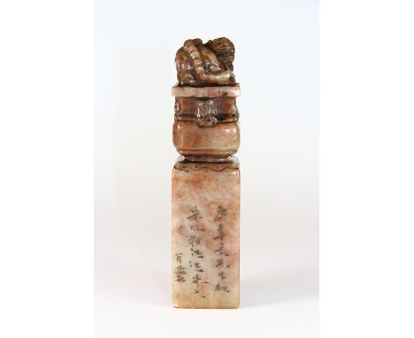 A large Chinese mixed colour hardstone seal mounted with a young dragon (15cm)