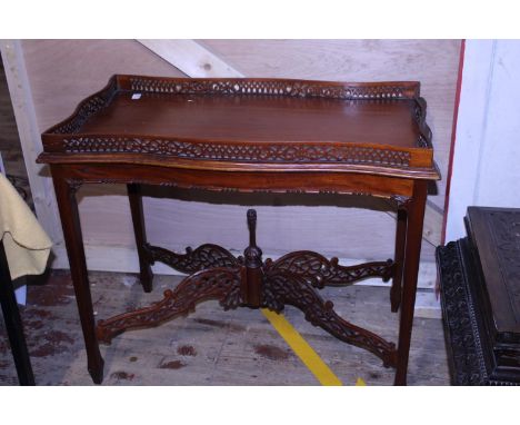 A vintage mahogany occasional table with fret work galleried top. Shipping unavailable. 