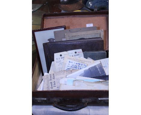 A vintage suitcase full of assorted ephemera, postcards, photos mainly from WW2 period 