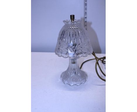 A glass hurricane style electric lamp 