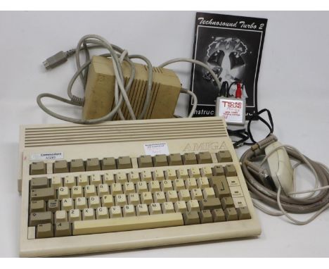 Commodore Amiga A600 computer system, working and boots, with power supply, mouse and technosound turbo peripheral. All elect