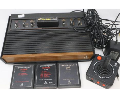 Atari video computer system with four game cartridges, joy stick and power supply. All electrical items in this lot have been