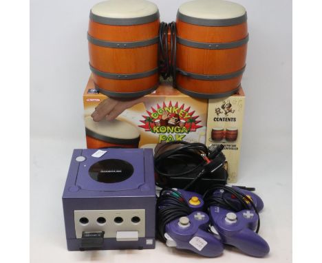 Nintendo Game Cube model DOL-001 circa 2001 gaming console with two controllers, power supply and boxed Donkey Konga Pak. All