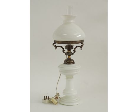 A Bohemian white opaline glass oil lamp with original white glass shade and chimney, converted to electricity. H60cm. C1900.