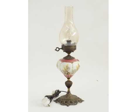 An Austrian ceramic oil lamp with original glass shade, converted to electricity. H58cm. C1900.