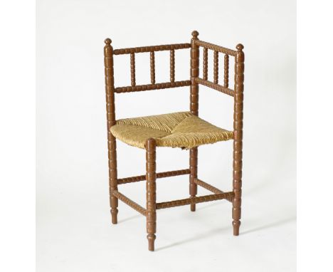 A Cypriot provincial corner chair, brown painted turned bobbin beechwood with a straw seat. 43x45cm, H82cm. Mid 20th century.