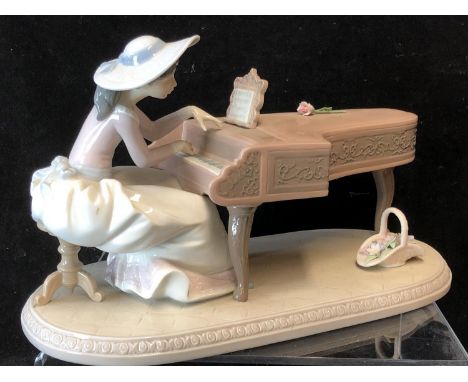 Lladro Porcelain- Spring Recital, No 6427, a young girl in a broad rimmed hat seated at a grand piano, 33cm max, original box
