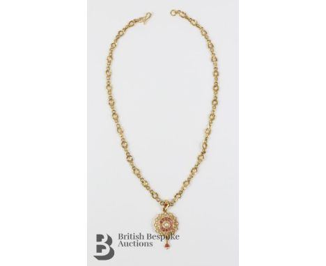 Indian 18+ct yellow gold pearl and ruby pendant. The pendant set with 1 x 2.2 mm ruby; 1 x 2mm ruby and 12 x 1.8mm, suspended