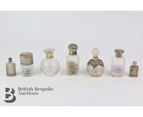 Seven antique perfume bottles, the first of cylindrical form with silver collar and cover, London hallmark dated 1893 mm Samu