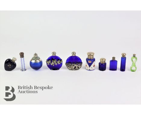 Nine coloured glass scent bottles, including a Bristol-blue heart-shaped bottle Birmingham hallmark dated 1900; a fine Nailse