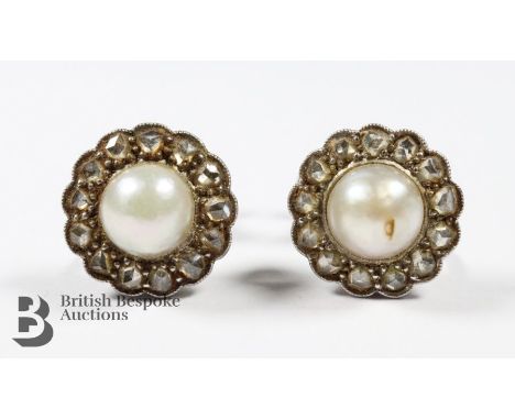 A pair of 14/15ct yellow gold pearl and diamond screw-back earrings, 3.7 gms. The earrings set with 2 x 6.3mm pearls and appr