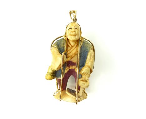 An Antique Japanese Netsuke pendant 19th century, the carved ivory netsuke modeled as a standing gentleman, dressed in tradit